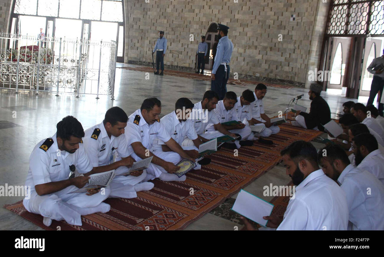 Pakistan Navy personnel are reciting Holy Quran for the departed soul of founder of Pakistan on the occasion of Quaid-e-Azam Muhammad Ali Jinnah's 67th death anniversary, at mausoleum in Karachi on Friday, September 11, 2015. Stock Photo