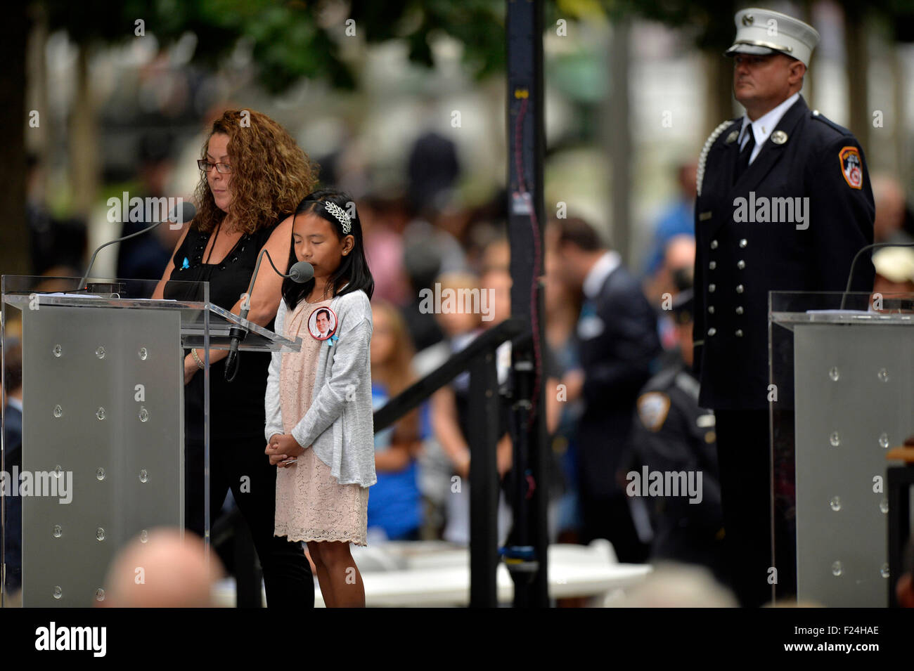 New York, USA. 11th Sep, 2015. Victims' family members read the victims' names during a remembrance ceremony of the 14th anniversary of the Sept. 11 attacks at the World Trade Center site in New York on Friday, Sept. 11, 2015. © Wang Lei/Xinhua/Alamy Live News Stock Photo