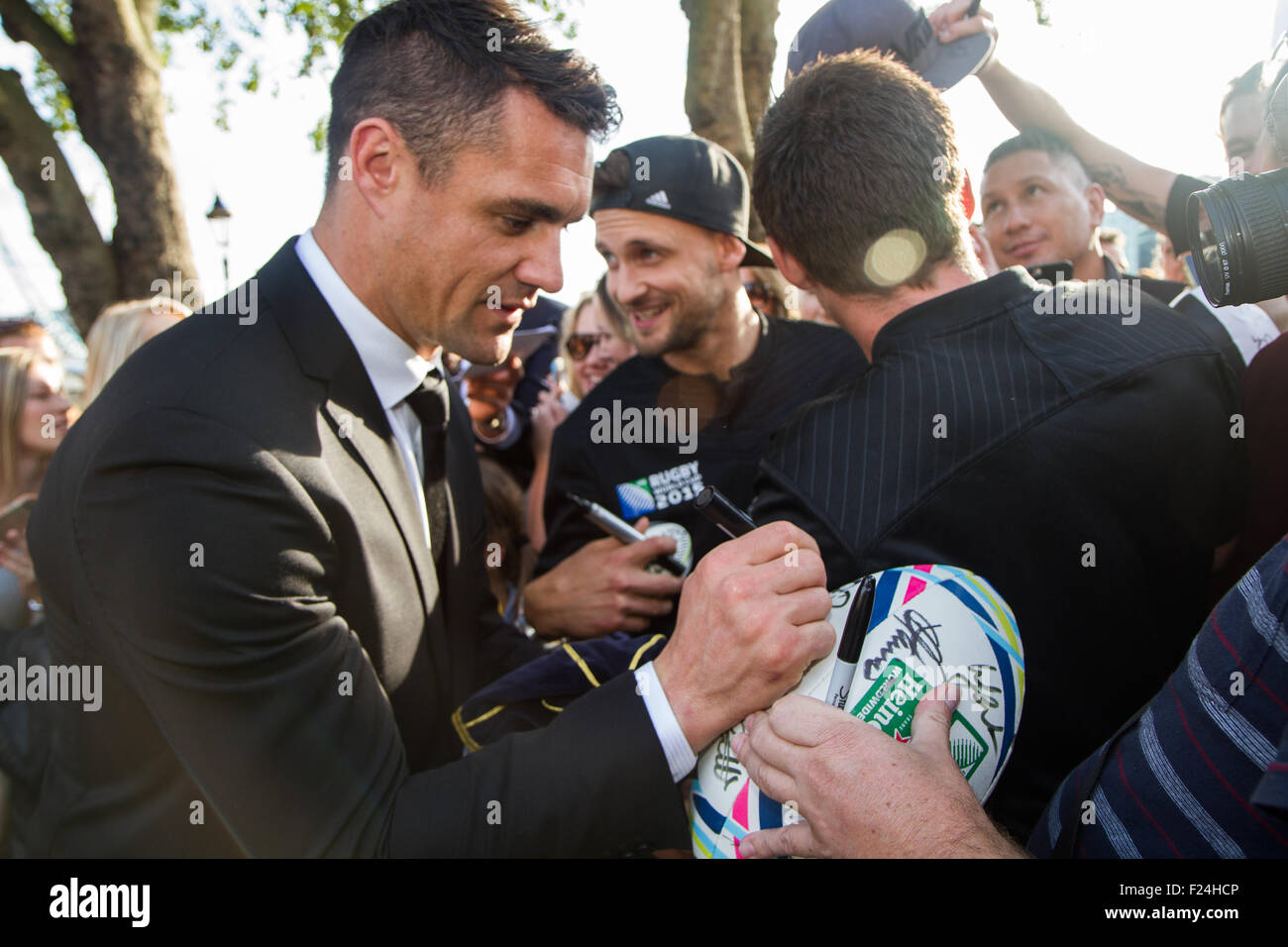 London, UK. 11th September 2015. Dan Carter signing autographs to waiting fans at Tower Bridge after the welcoming ceremony for the New Zealand rugby team for the 2015 Rugby World Cup. 20 teams from around the world will be competing to win the Webb Ellis Cup and declared RWC 2015 winners. New Zealand are the current title holders, winning the trophy in 2011. Credit: Elsie Kibue / Alamy Live News Stock Photo
