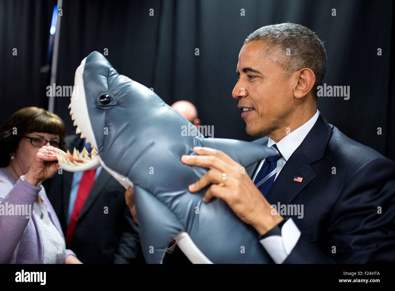 U.S. President Barack Obama holds an inflatable shark as he waits backstage prior to a town hall meeting with online communities BlogHer and SheKnows regarding working families issues at ImaginOn April 15, 2015 in Charlotte, N.C. Stock Photo