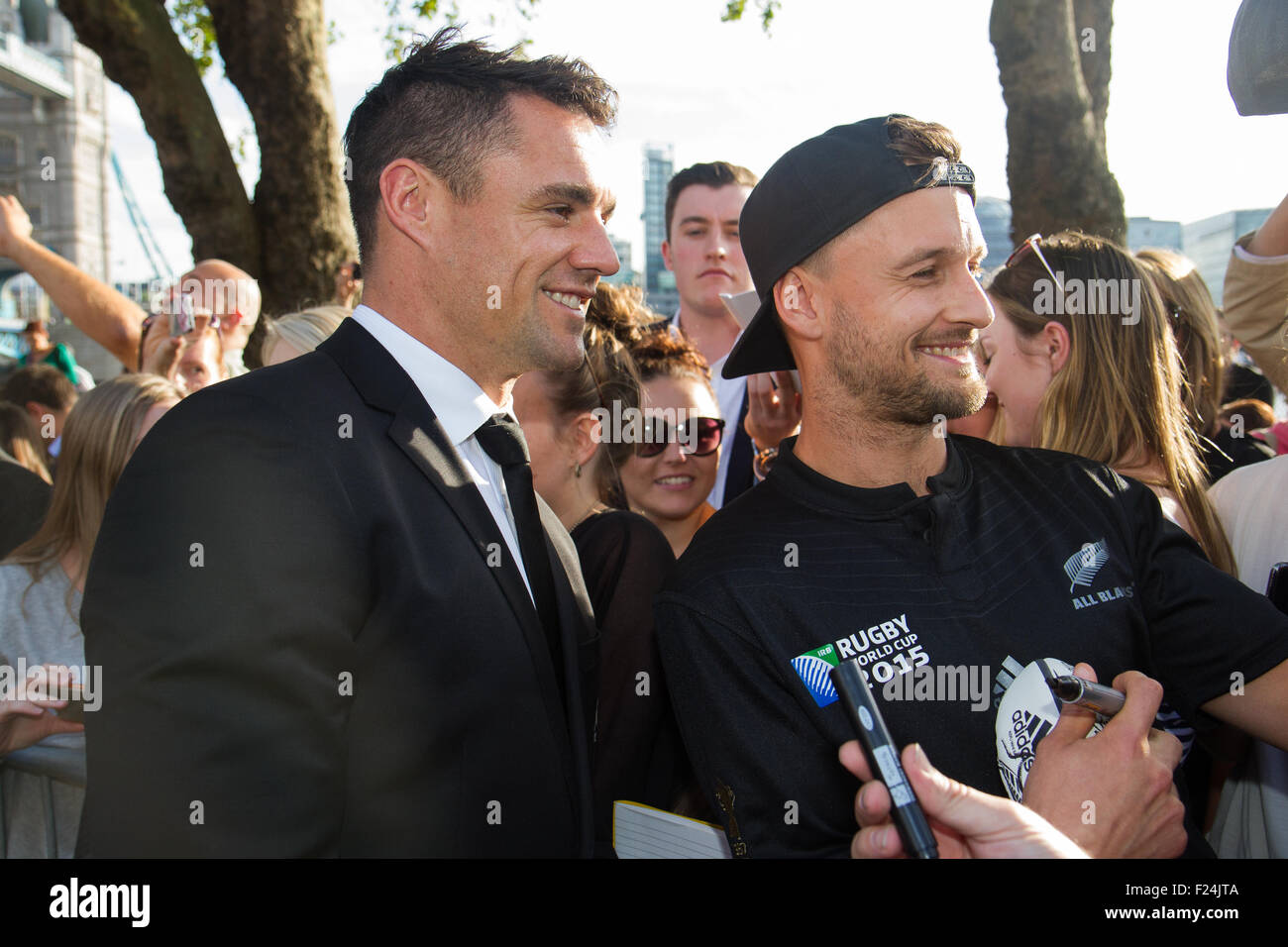 London, UK. 11th September 2015. Dan Carter poses for a picture with a fan at Tower Bridge after the welcoming ceremony for the New Zealand rugby team for the 2015 Rugby World Cup. 20 teams from around the world will be competing to win the Webb Ellis Cup and declared RWC 2015 winners. New Zealand are the current title holders, winning the trophy in 2011. Credit: Elsie Kibue / Alamy Live News Stock Photo