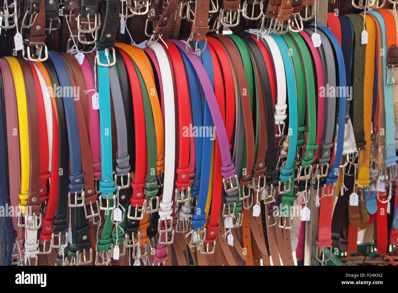Belts on sale cheaply in a market stall in Minorca Stock Photo