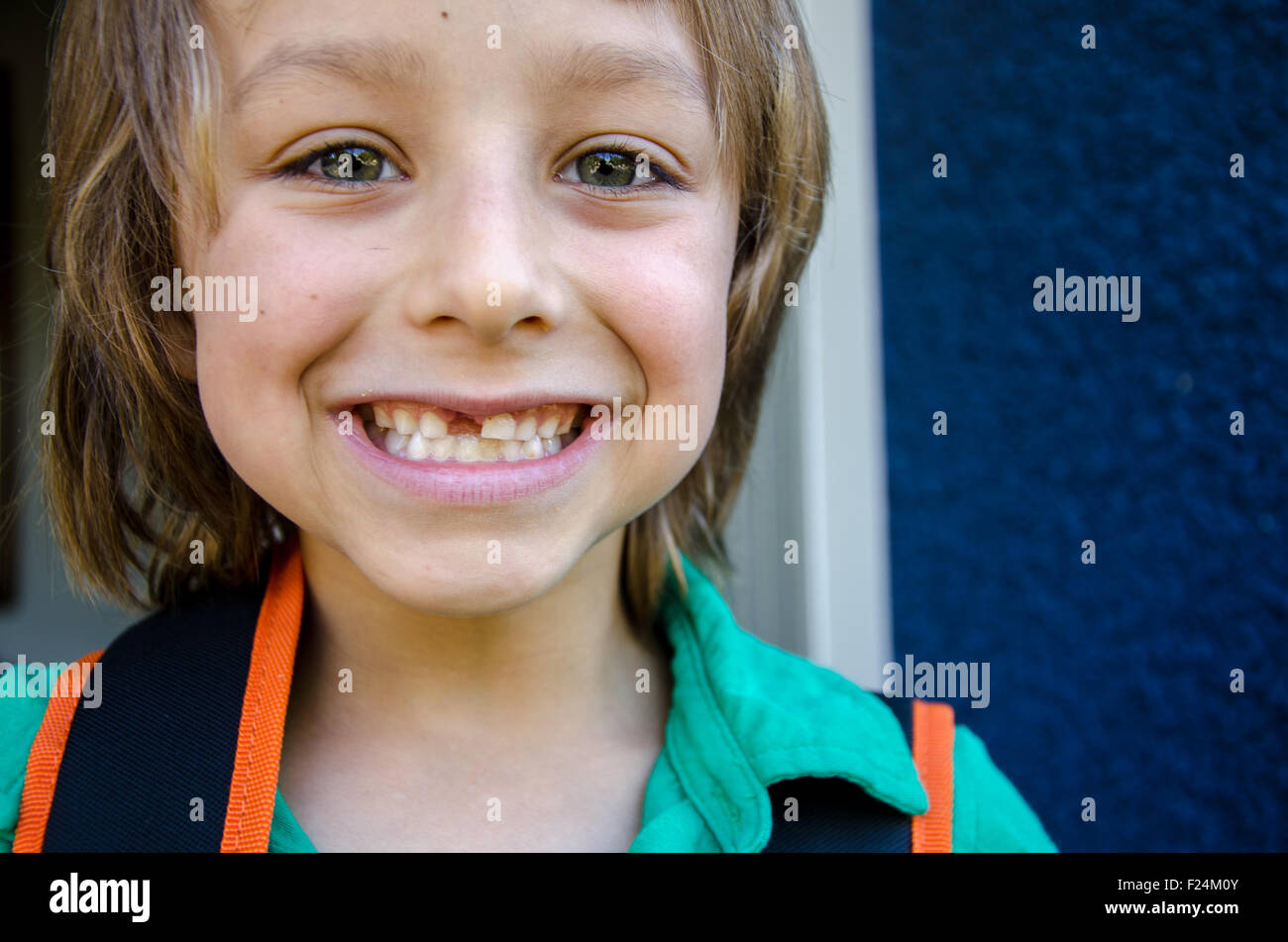 A smiling boy leaves for his first day of school in Vancouver, British Columbia, Canada. Stock Photo
