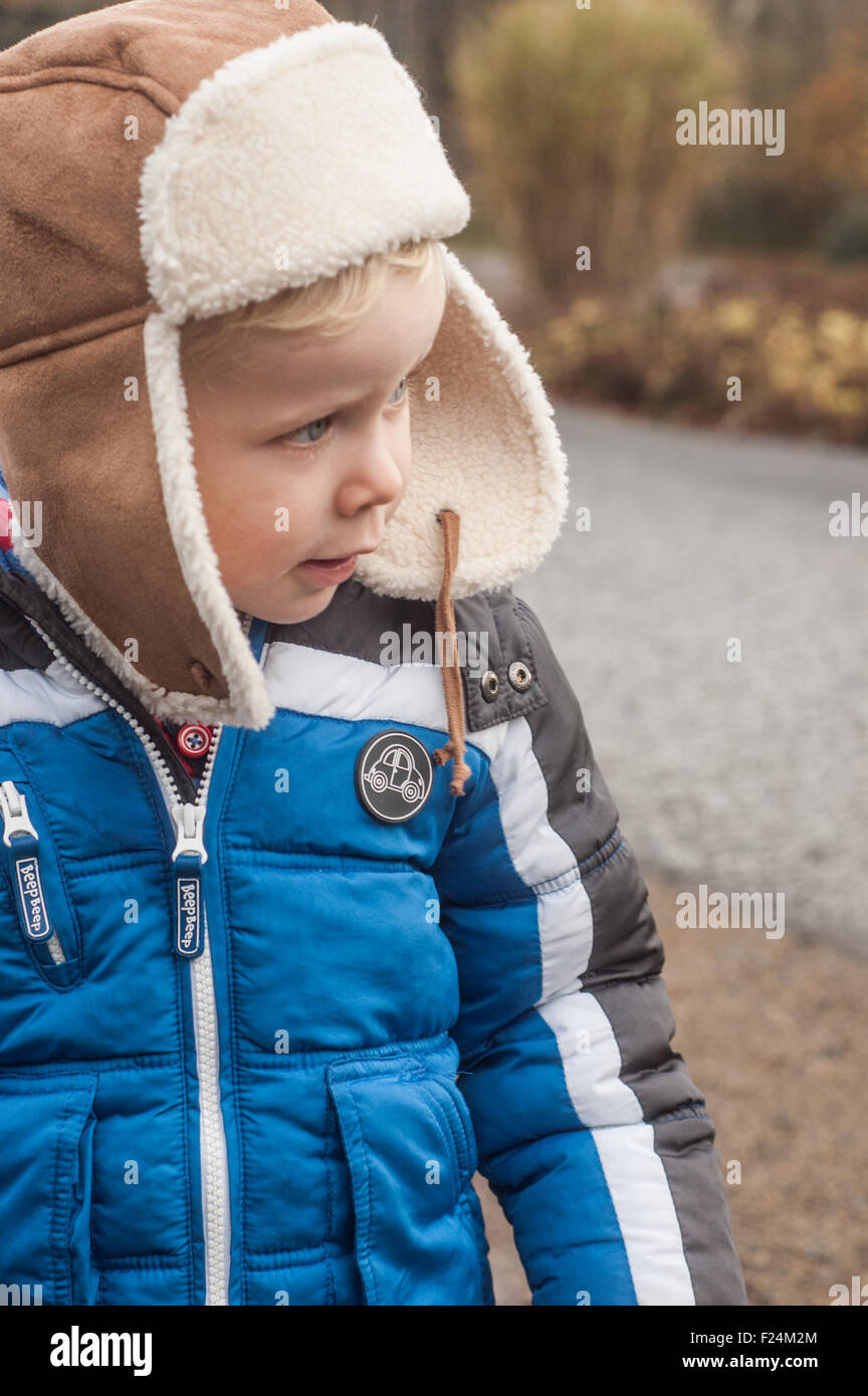 Boy looking with ear warmer hat at Eglington Park, Scotland Stock Photo