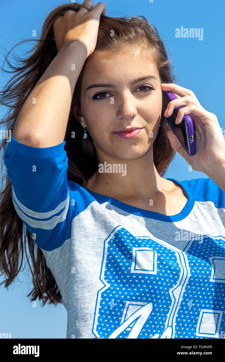 Beautiful teenage girl calling on mobile phone Stock Photo