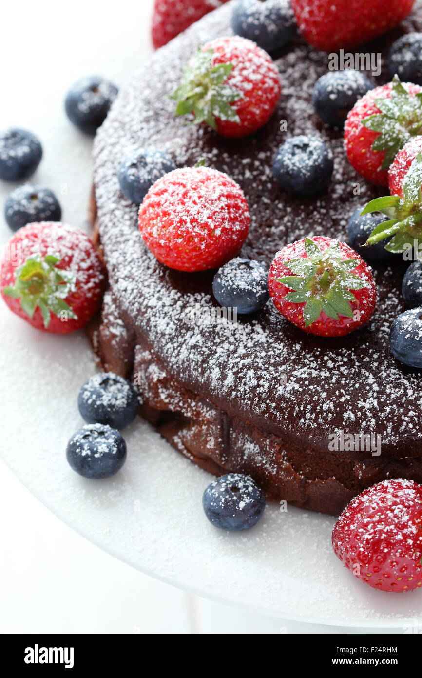 Close up of chocolate cake with berries on top Stock Photo - Alamy