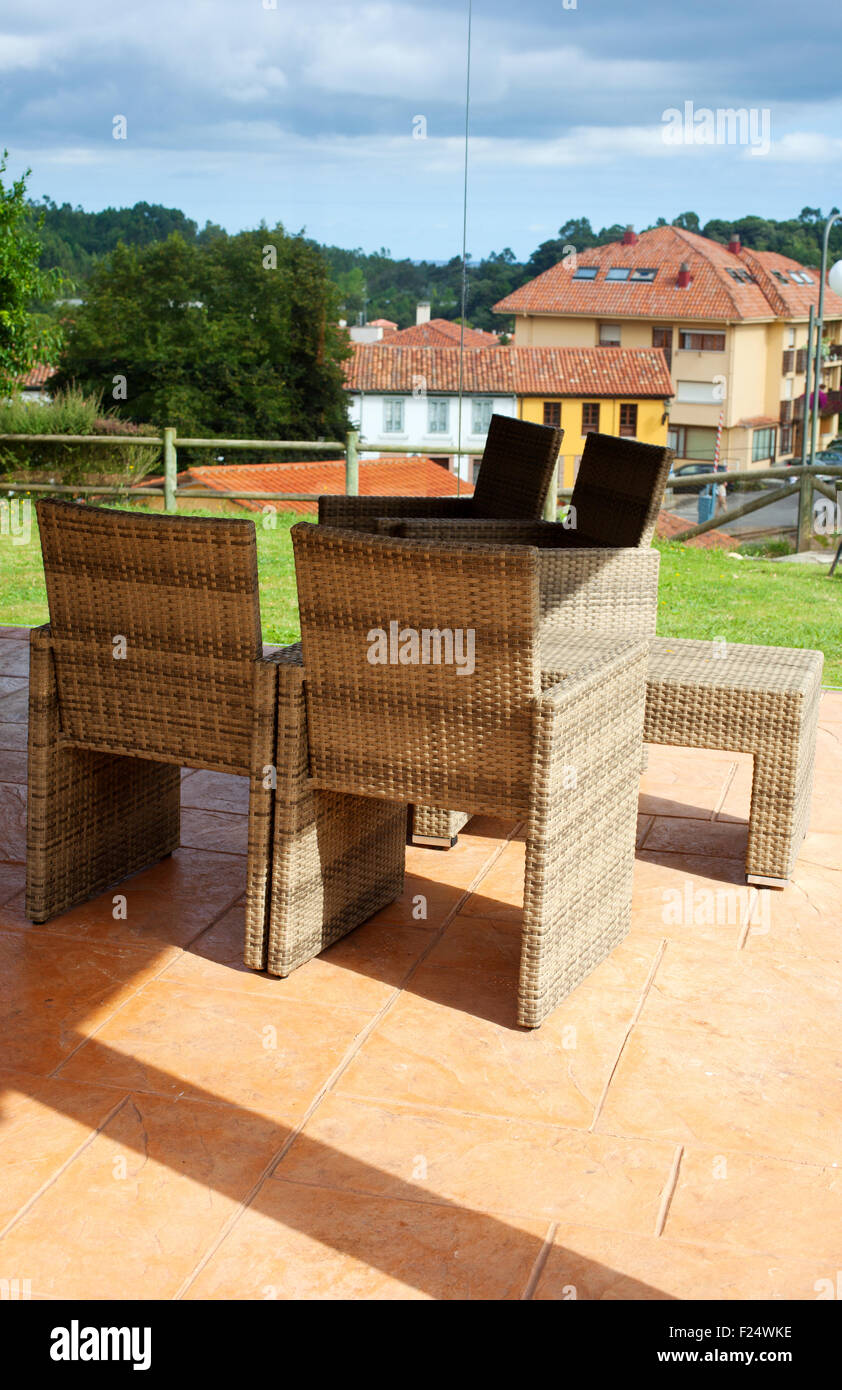 Wicker table and chairs in a garden Stock Photo - Alamy