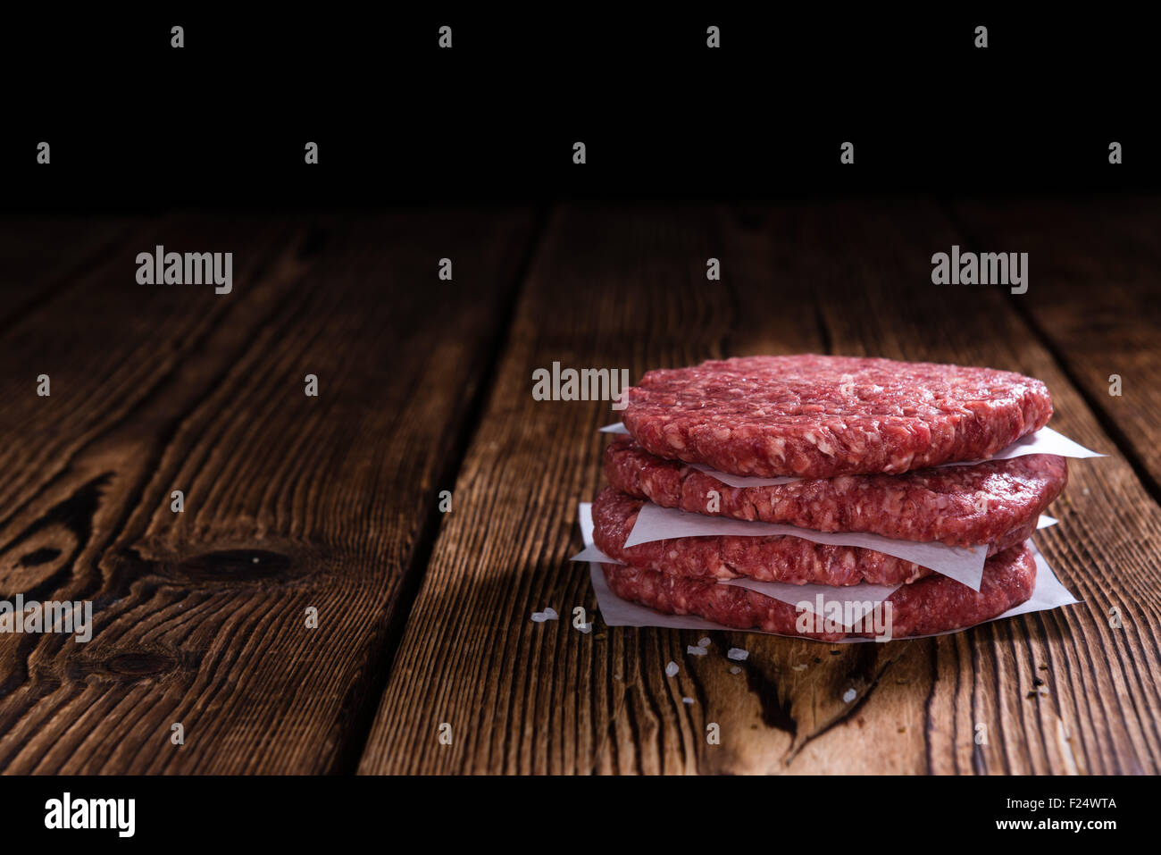 Some fresh made Burgers (raw minced Beef) on an old wooden table Stock Photo