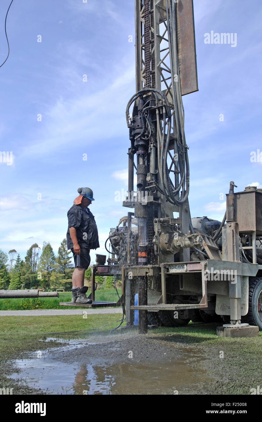 Crew working a drilling rig in the search for bore water, Westland Stock Photo