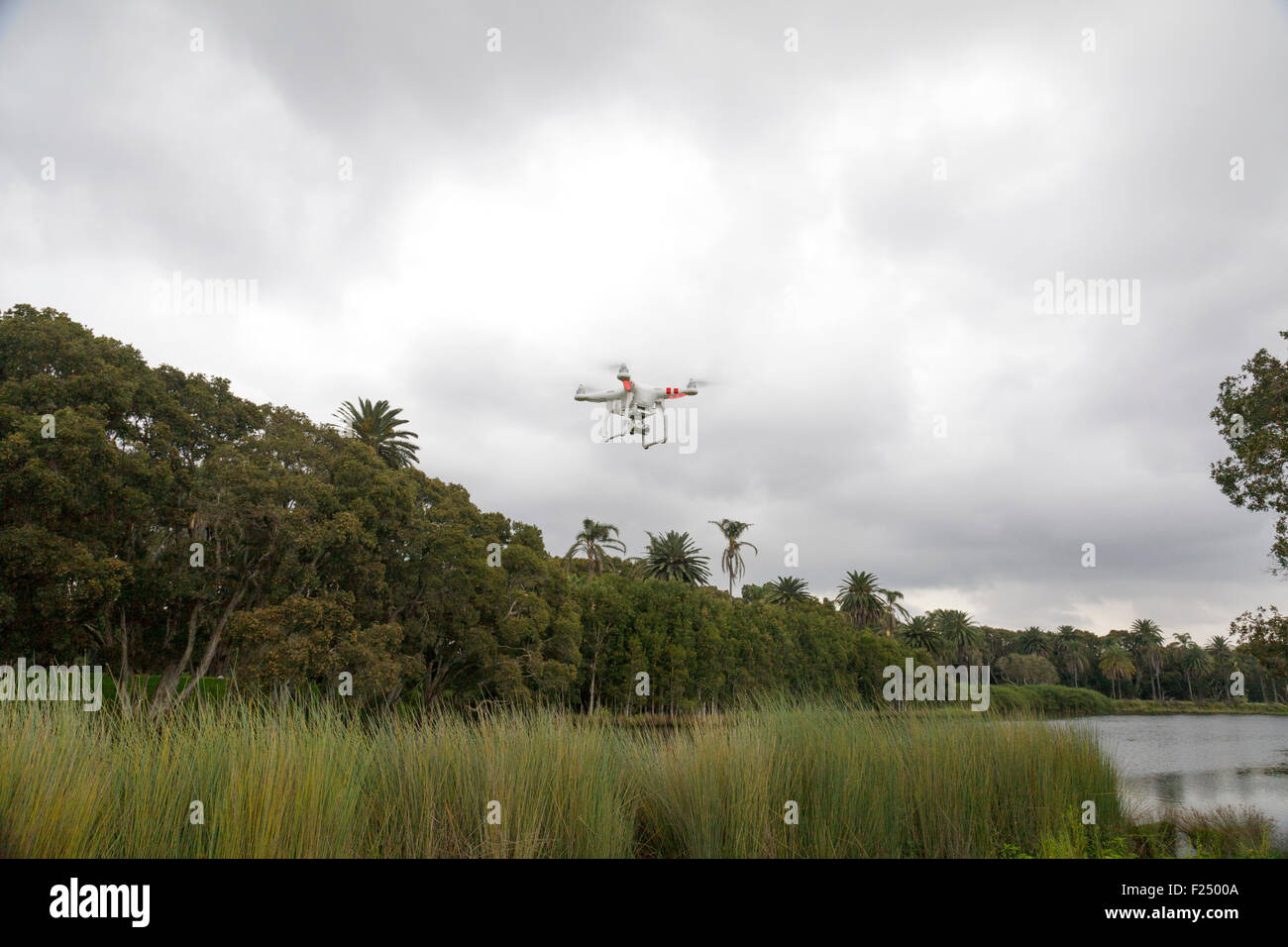 A flying drone with a gimbal and camera attached. Stock Photo
