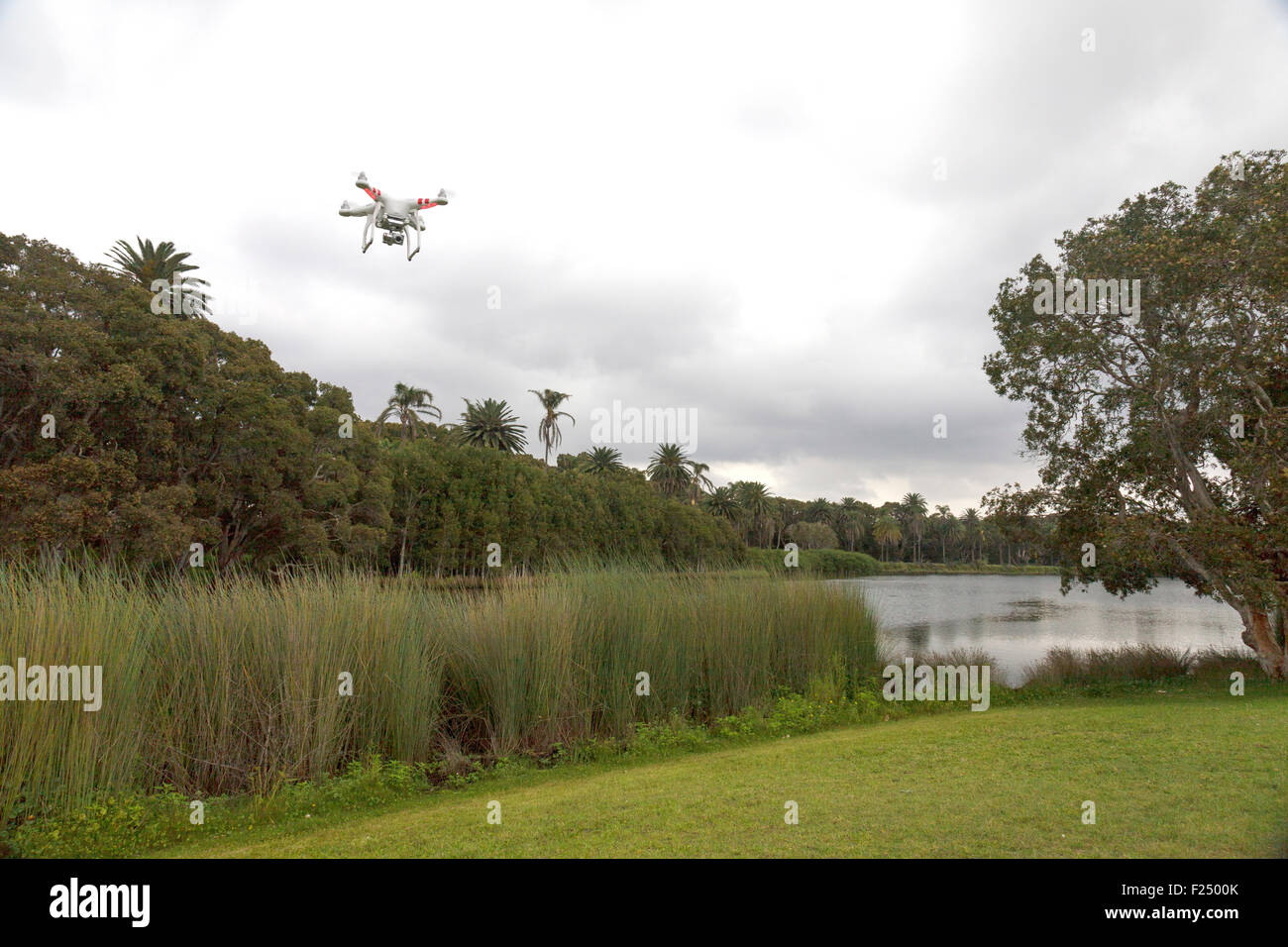 A flying drone with a gimbal and camera attached. Stock Photo