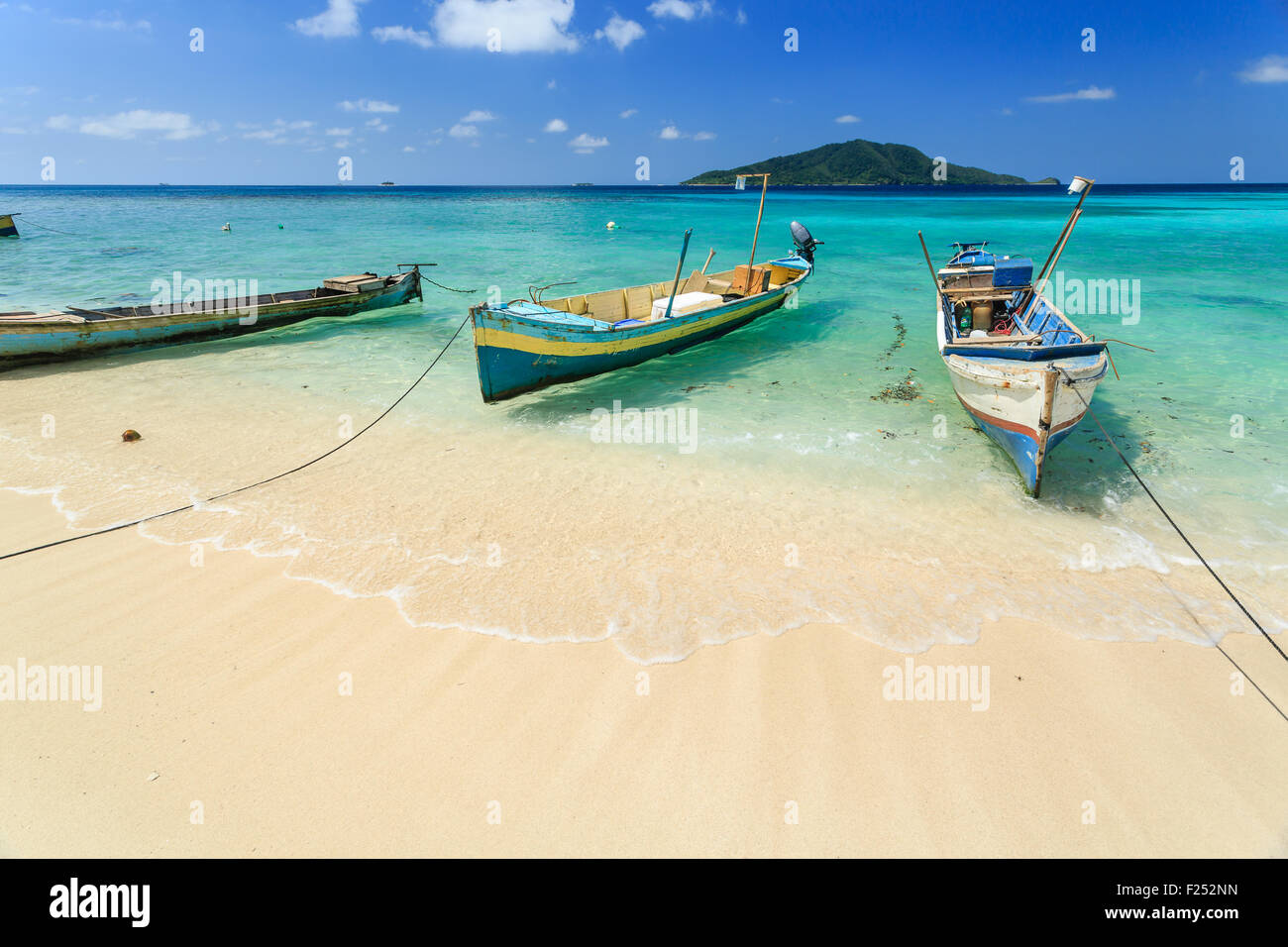 Wooden boats anchored on tropical beach Stock Photo - Alamy