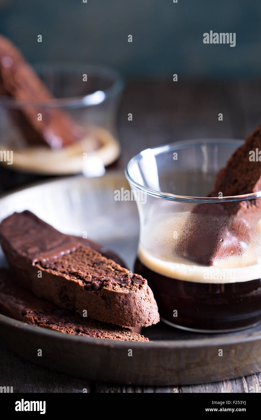 Chocolate biscotti cookies dipped in chocolate with a cup of coffee Stock Photo