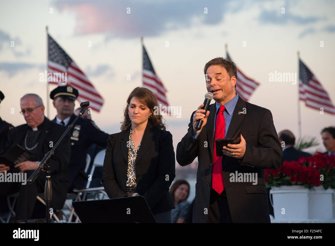 Staten Island, United States. 11th Sep, 2015. Singers Alison Madil (left) and Reverend Timothy Mercaldo (right) perform a song at the commemoration ceremony. NYC officials including Mayor Bill de Blasio (not seen) and Staten Island Borough President James Oddo (not seen) participated in a commemoration ceremony for the the 274 Staten Island residents who died in the attack on the World Trade Center. Credit:  Albin Lohr-Jones/Pacific Press/Alamy Live News Stock Photo