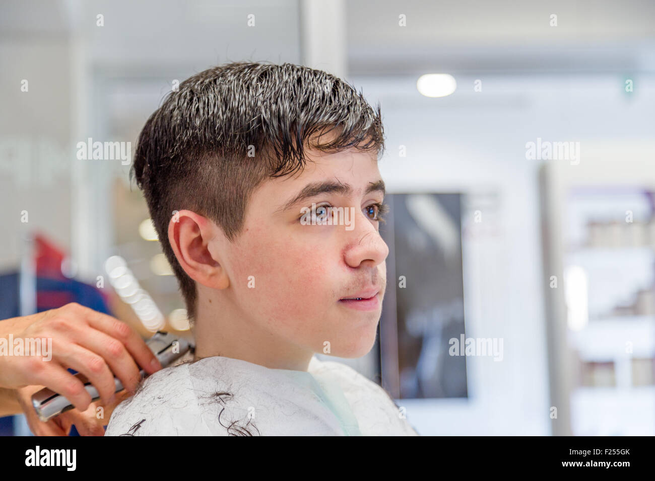 Cute Caucasian Teenage Boy With Brace Sitting At The Hairdresser