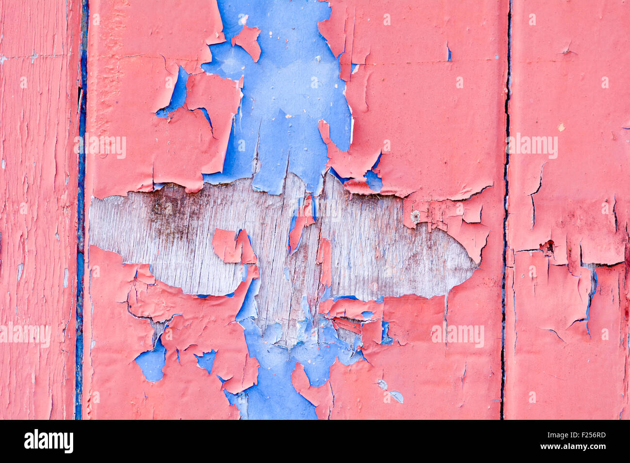 Red and blue flaked paint on wooden door Stock Photo