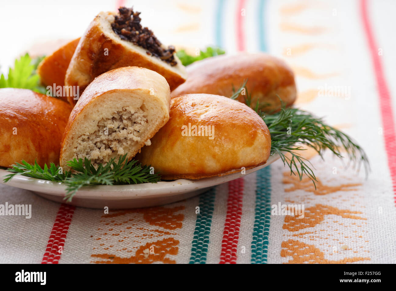 Russian pirozhki (baked patties) on wooden cutboard Stock Photo