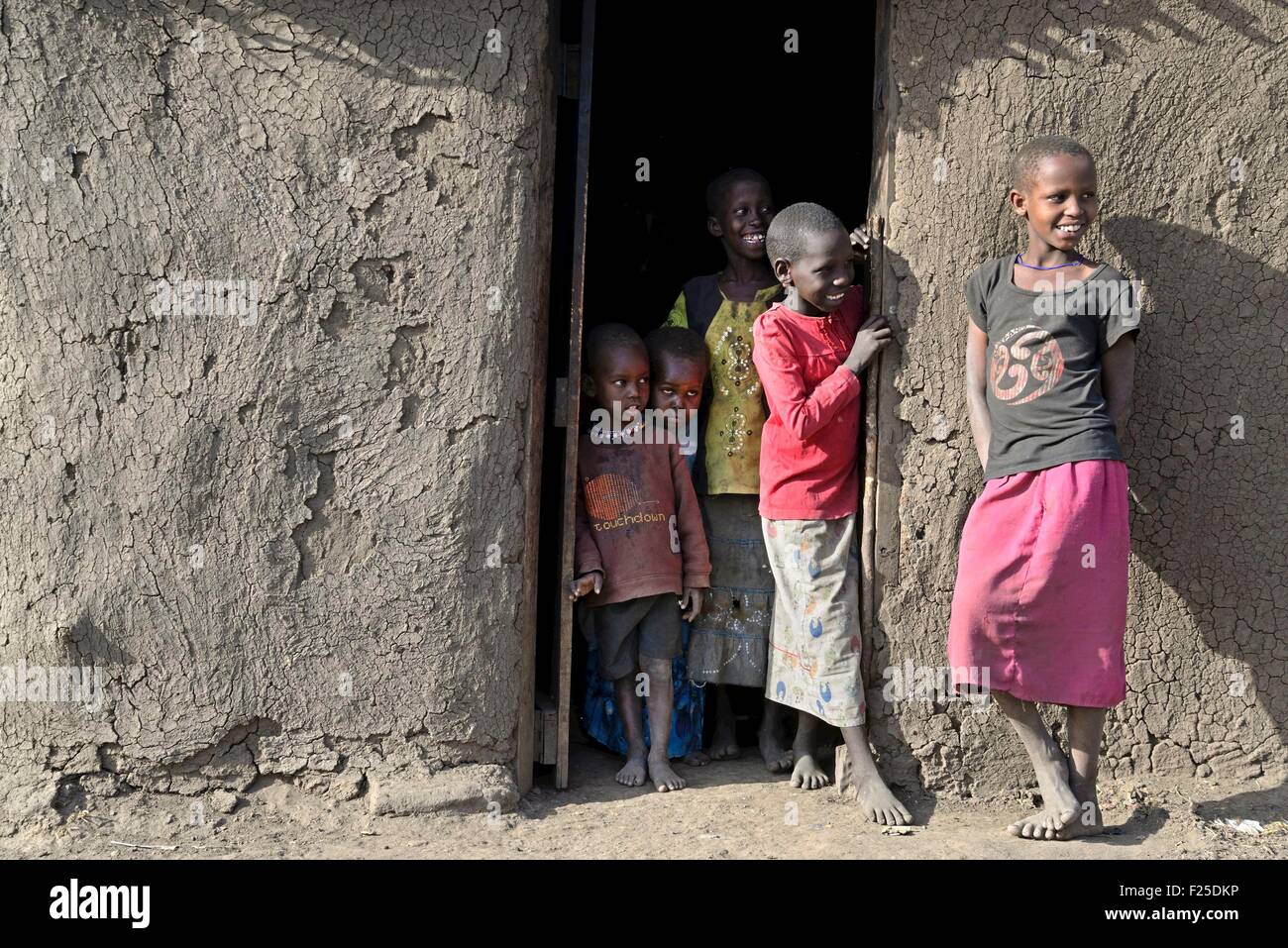 Kenya, Masai Mara Reserve, Masai young children at the entrance to their huts in a traditional village Massai Stock Photo