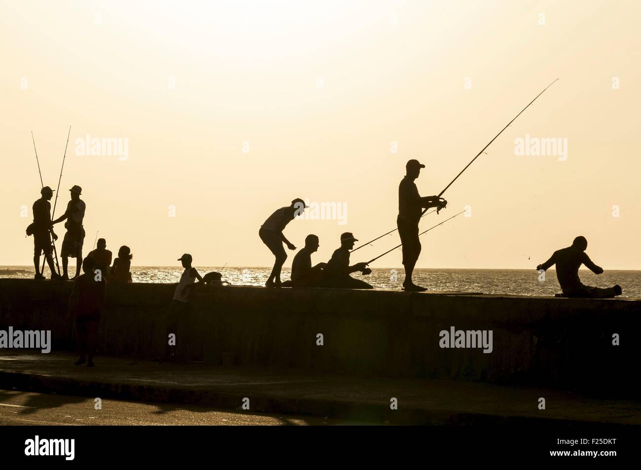 Cuba, Havana, Malecon, Habana Vieja district listed as World Heritage by UNESCO, fishermen at evening time Stock Photo