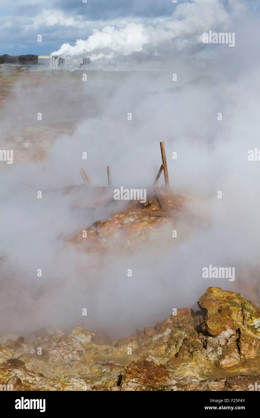 Iceland, South coast, Reykjanes Peninsula, Grindavik, sulfur steam escaping hot spring, Reykjanesvirkjun geothermal plant at background Stock Photo