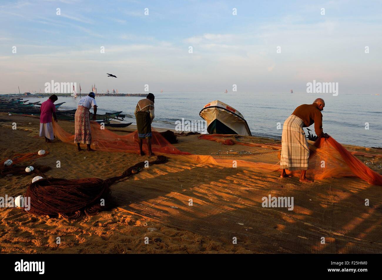 Sri Lanka, Western Province, Negombo, fishermen sorting their nets on the Porathota beach Stock Photo