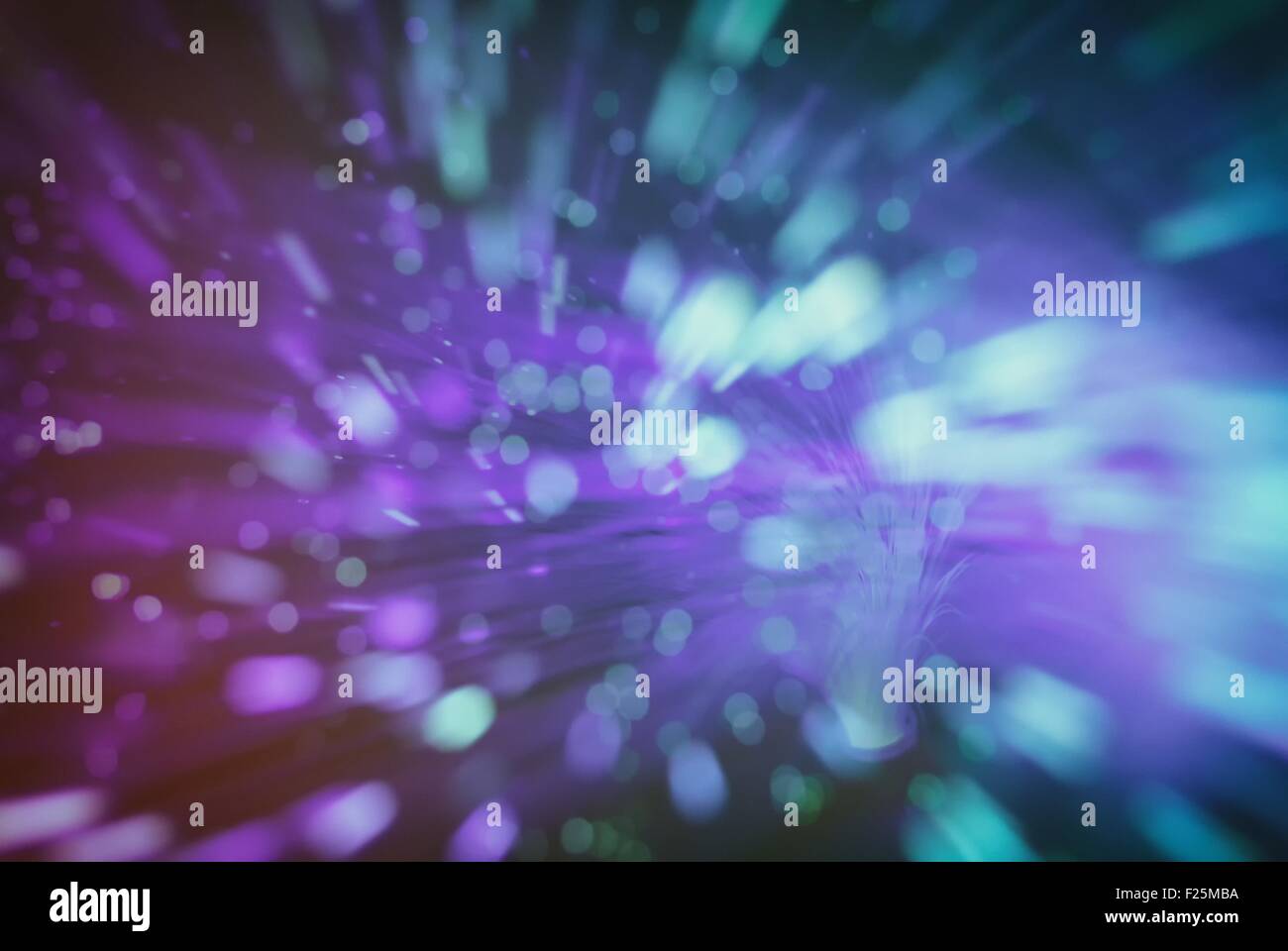 colored particles fly in space of the optical fiber and circling ( abstract blur background  ) Stock Photo