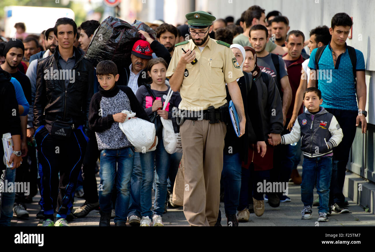 Munich, Germany. 12th Sep, 2015. Refugees, recently arrived by train, are accompanied to accommodation at the central station in Munich, Germany, 12 September 2015. PHOTO: SVEN HOPPE/DPA/Alamy Live News Stock Photo