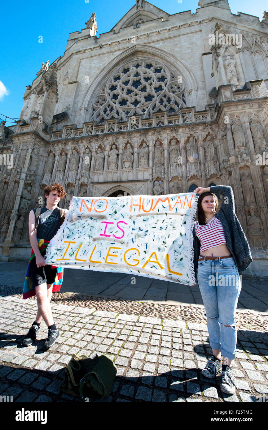 Exeter, Devon, UK. 12th Sep, 2015. A man and a woman hold a sign that says 'No Human is Illegal' during the Exeter Solidarity With Refugees Event outside the west front of Exeter Cathedral Credit:  Clive Chilvers/Alamy Live News Stock Photo