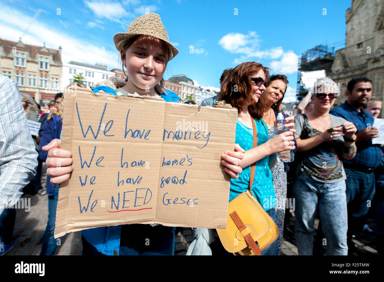 Exeter, Devon, UK. 12th Sep, 2015. Young woman holds a cardboard sign welcoming refugees to her home during the Exeter Solidarity With Refugees Event outside the west front of Exeter Cathedral Credit:  Clive Chilvers/Alamy Live News Stock Photo