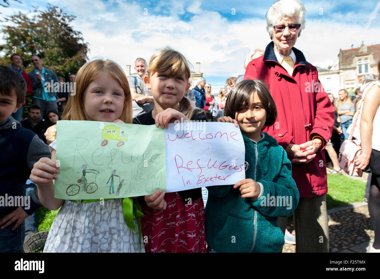 Exeter, Devon, UK. 12th Sep, 2015. Children hold up paper signs welcoming refugges to Exeter during the Exeter Solidarity With Refugees Event outside the west front of Exeter Cathedral Credit:  Clive Chilvers/Alamy Live News Stock Photo
