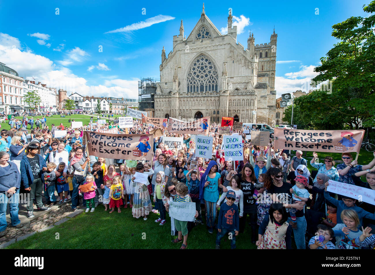 Exeter, Devon, UK. 12th Sep, 2015. The big crowd hold up their signs  and cheer during the Exeter Solidarity With Refugees Event outside the west front of Exeter Cathedral Credit:  Clive Chilvers/Alamy Live News Stock Photo
