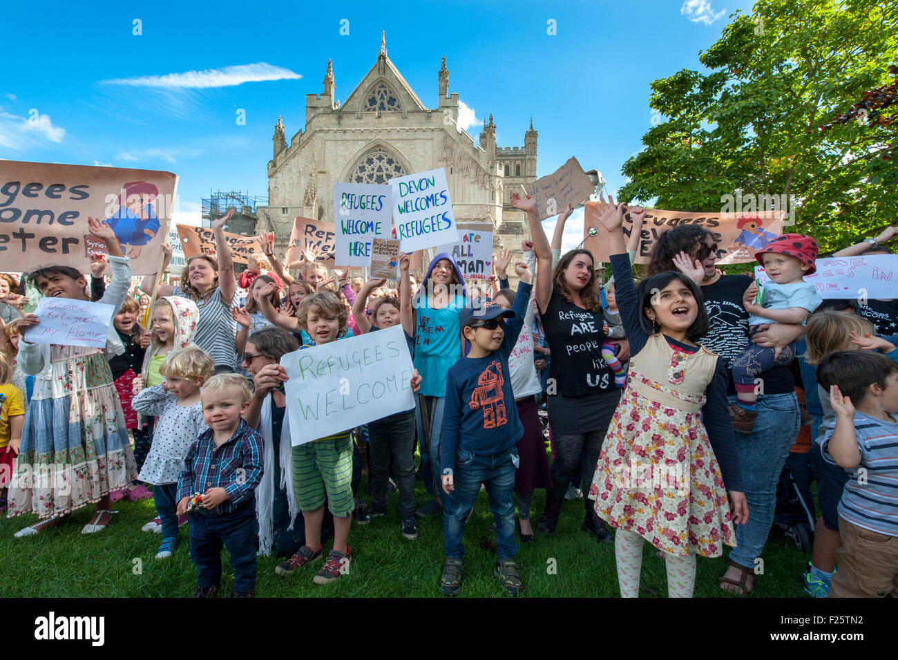 Exeter, Devon, UK. 12th Sep, 2015. Children and adults cheers and wave their signs during the Exeter Solidarity With Refugees Event outside the west front of Exeter Cathedral Credit:  Clive Chilvers/Alamy Live News Stock Photo