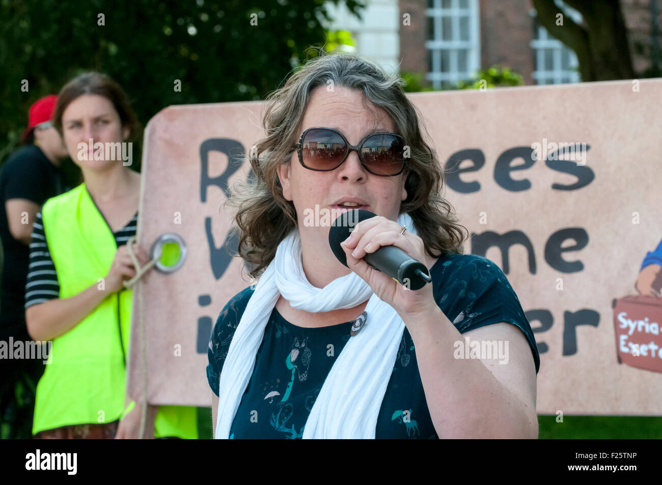 Exeter, Devon, UK. 12th Sep, 2015. Olivia Harker, from Exeter City of Sanctuary speaking during the Exeter Solidarity With Refugees Event outside the west front of Exeter Cathedral Credit:  Clive Chilvers/Alamy Live News Stock Photo