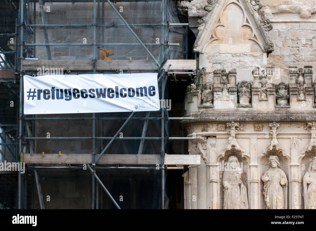 Exeter, Devon, UK. 12th Sep, 2015. A banner on the scaffolding on Exeter Cathedral saying '#refugeeswelcome' during the Exeter Solidarity With Refugees Event outside the west front of Exeter Cathedral Credit:  Clive Chilvers/Alamy Live News Stock Photo