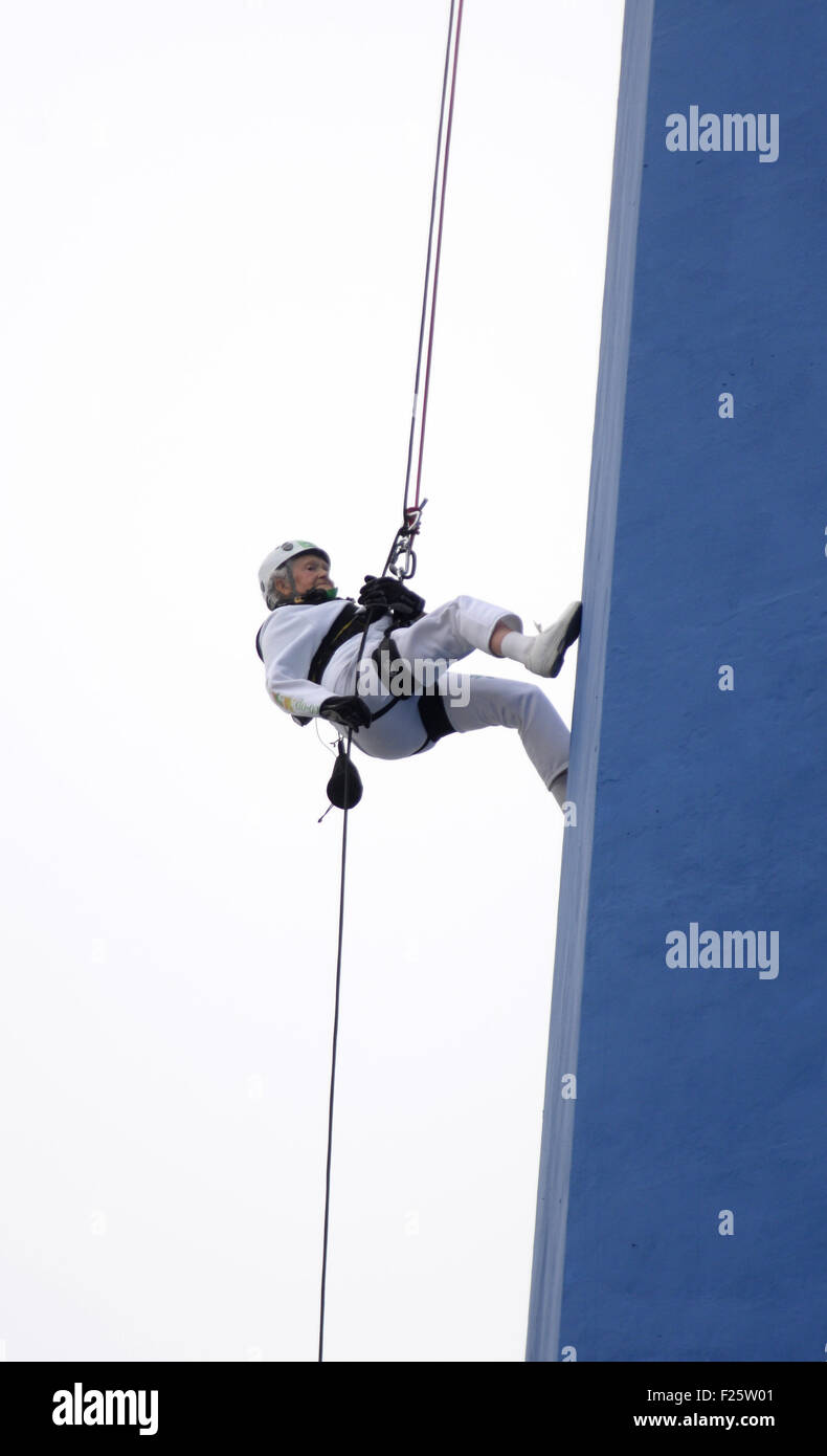 101 year old Doris Long makes a world record breaking abseil down the Portsmouth Emirates Spinnaker Tower in Hampshire. Doris Long is the oldest person to do an abseil in the World, 'Daring' Doris managed the 320ft abseil in just over half an hour with a large crowd watching on a cold, wet and windy day  Featuring: Doris Long Where: Portsmouth, United Kingdom When: 12 Jul 2015 Stock Photo