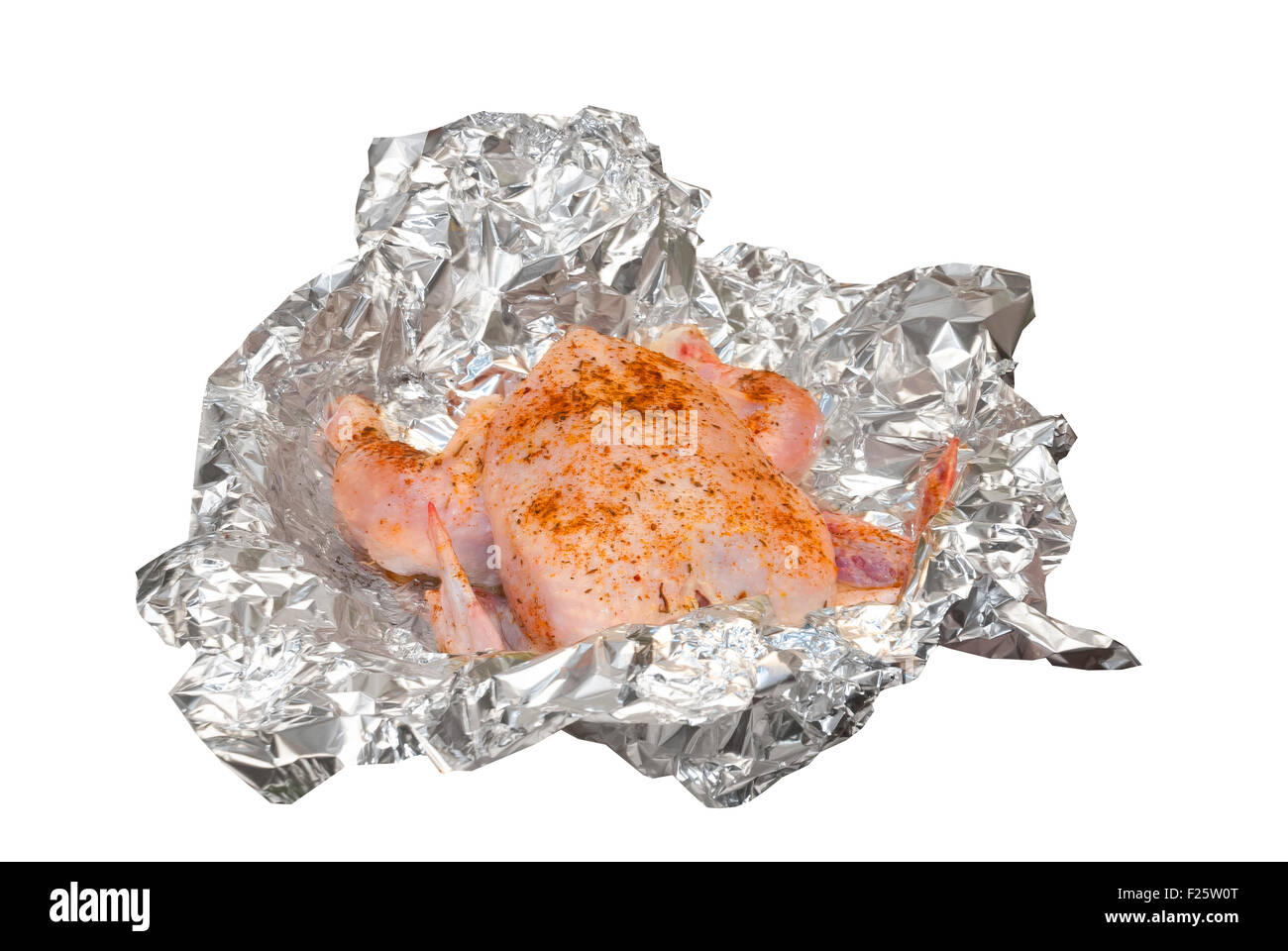 crude chicken preparation with spices for grill in foil Stock Photo