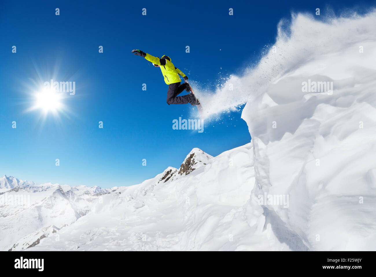 Jumping snowboarder at jump Stock Photo