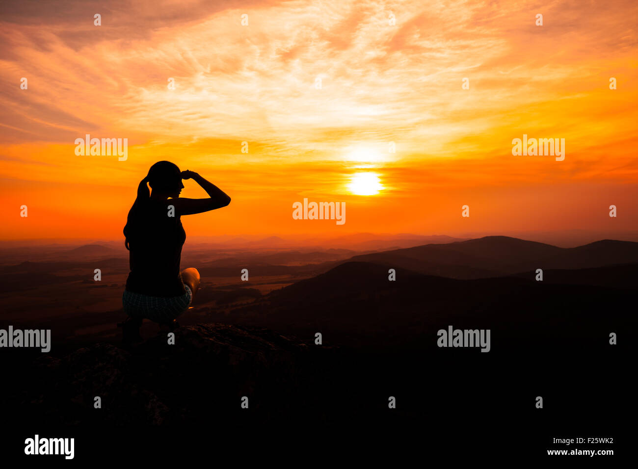 Silhouette of woman watching sunset and pointing Stock Photo - Alamy