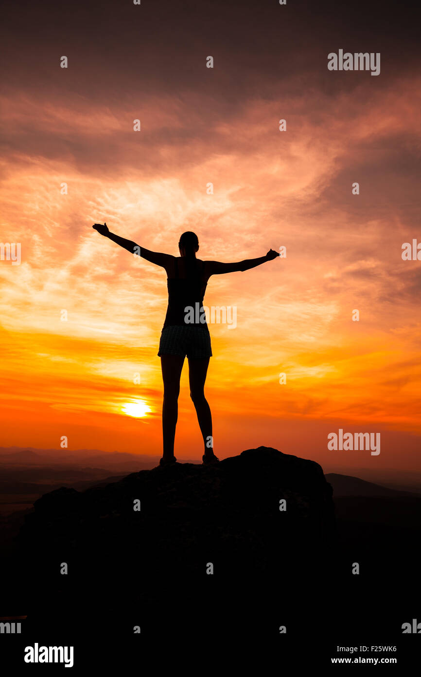 Silhouette of woman watching sunset Stock Photo - Alamy