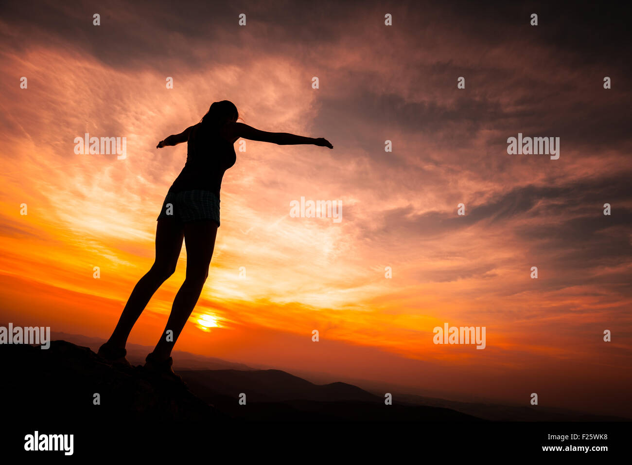 Silhouette of woman watching sunset Stock Photo - Alamy