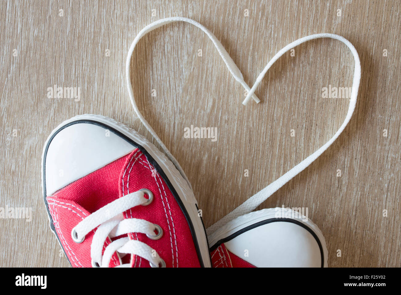 Heart shape made with laces of a red sneakers on a parquet floor Stock  Photo - Alamy