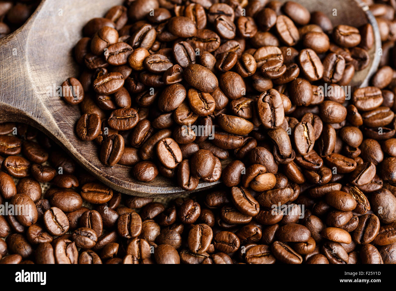 Coffee beans on a wooden spoon Stock Photo