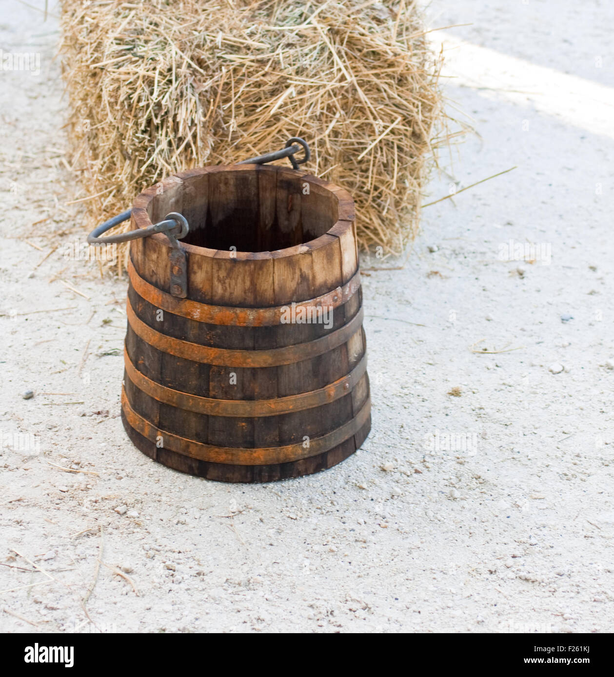 Wooden bucket and bale of hay Stock Photo Alamy