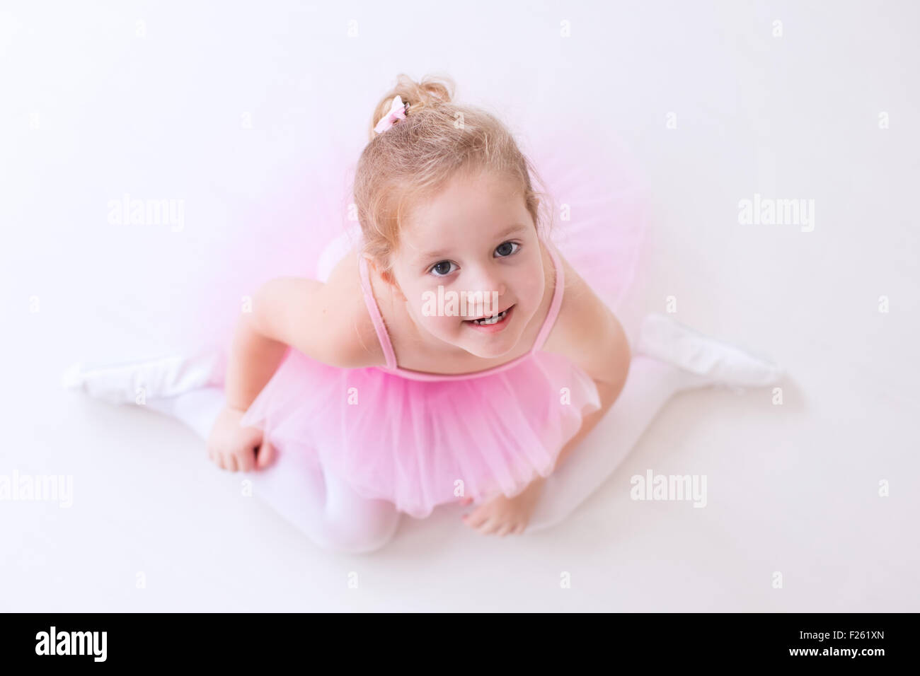 Adorable photo of little ballerina in a lilac dress and white