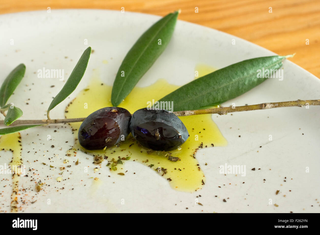 Black Olives and oil on dish Stock Photo Alamy