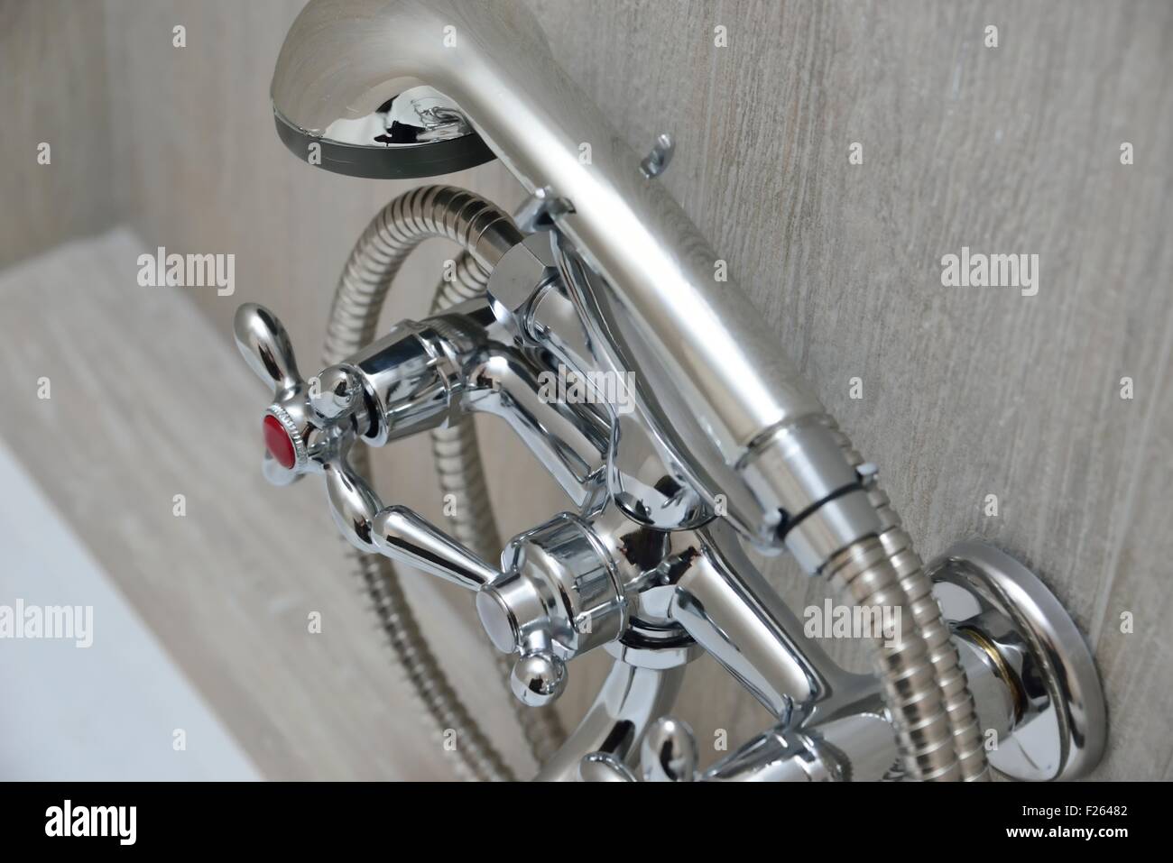 Chrome Faucet In Bathroom With Separate Taps And Showerhead Stock