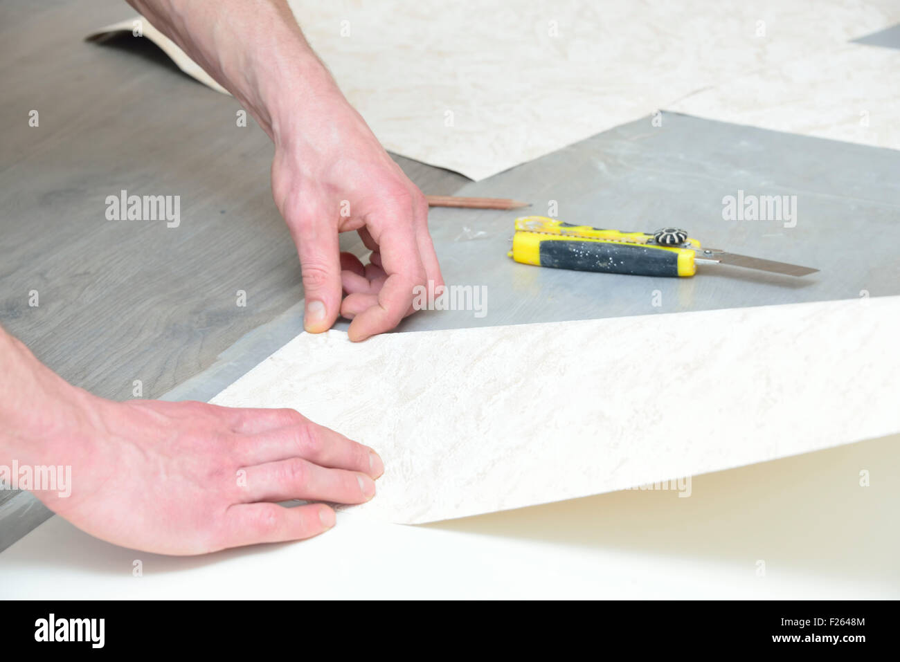 preparation for cutting and gluing wallpaper (measurement and marking) Stock Photo
