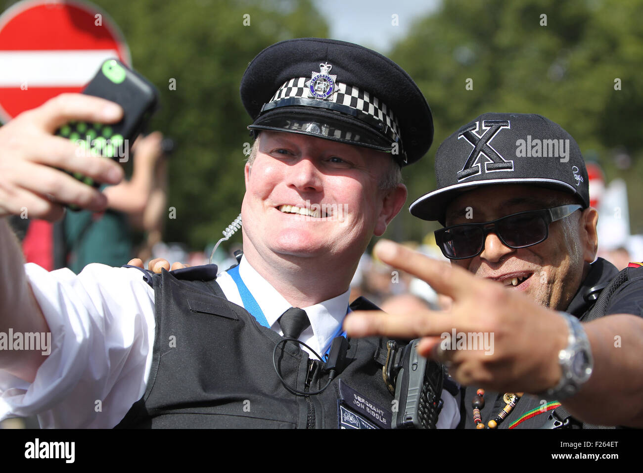 London, UK. 12th Sep, 2015. A police officer has his photo taken with a protestor during the Solidarity with Refugees march in central London. Credit:  Randi Sokoloff/Alamy Live News Stock Photo