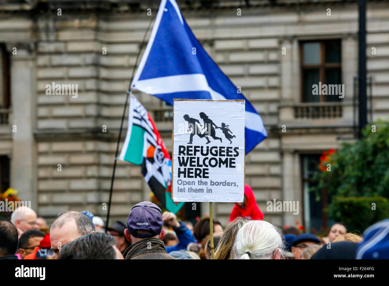 Glasgow, Scotland, UK. 12th Sept, 2015. Despite the heavy rain, about 2000 people attended a candlelight vigil in George Square, Glasgow showing support for the Syrian refugees. Recently Glasgow Council who already provides homes for 55 Syrians, announced  that it will take an additional 60 refugees. Frank McAveety, the newly appointed leader of Glasgow Council attended the rally. Credit:  Findlay/Alamy Live News Stock Photo
