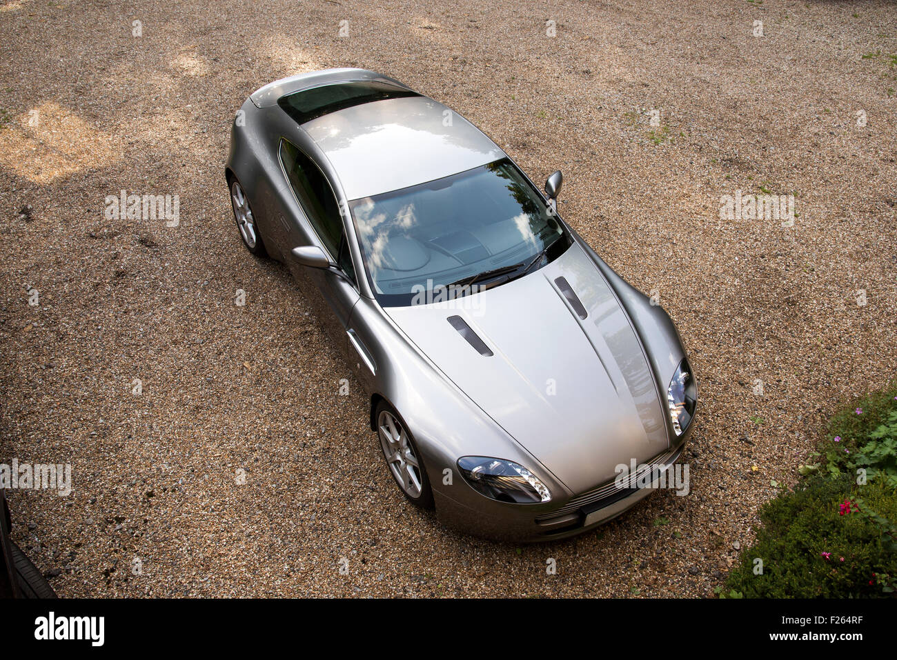 Overview of a luxury two door sports car standing on a gravel driveway Stock Photo